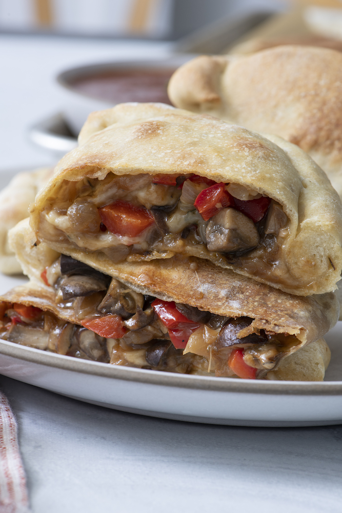 Vegetarian Calzones sliced in half and stacked on top of each other. 